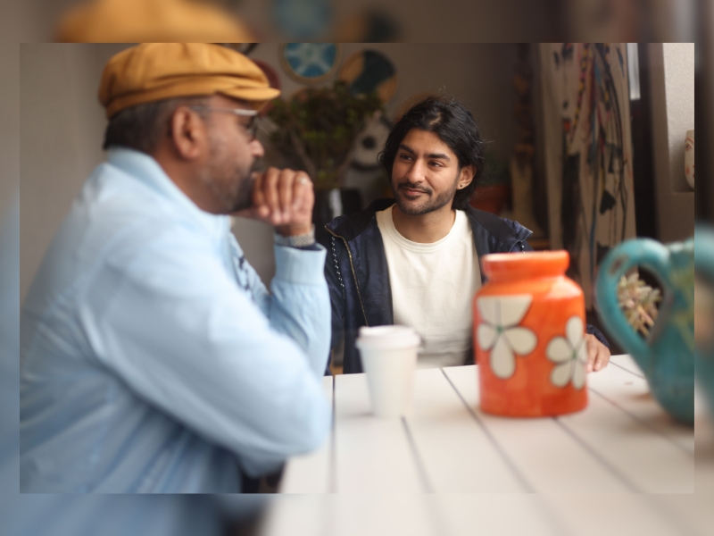 Two men talking over coffee, sharing thoughts on effective medication management and support services.