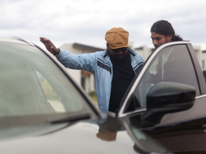 A man providing travel assistance to a person, ensuring accessibility and support during their journey.