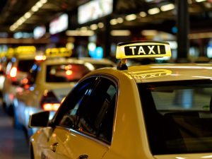 A line of taxis at a stand, highlighting the availability of accessible transport options for passengers.