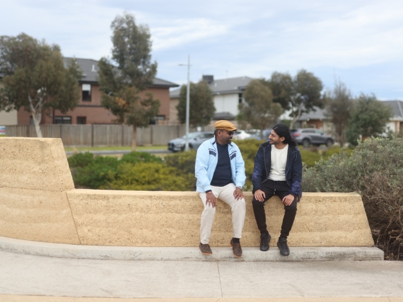 Two people chatting on the sidewalk, enjoying their time together as a perfect travelling companion.