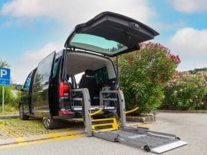 Taxis for disabled people: a wheelchair-accessible van with a ramp extended, ready for use.