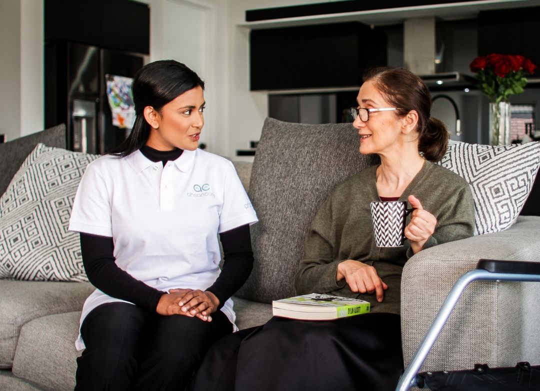 Support worker discussing housing and tenancy support with a woman at home