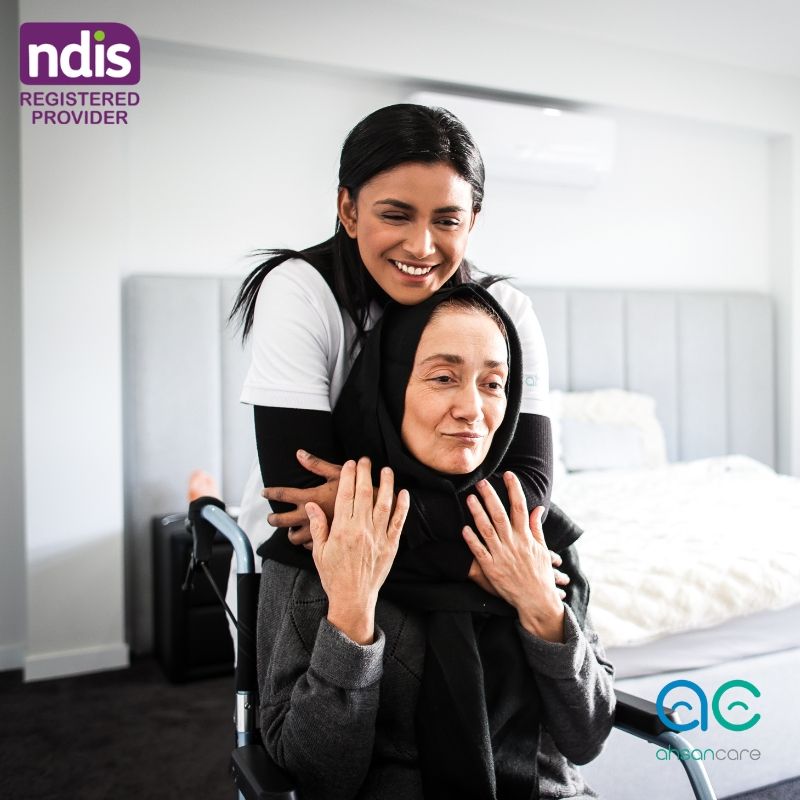 NDIS support worker providing compassionate in-home disability support beside wheelchair