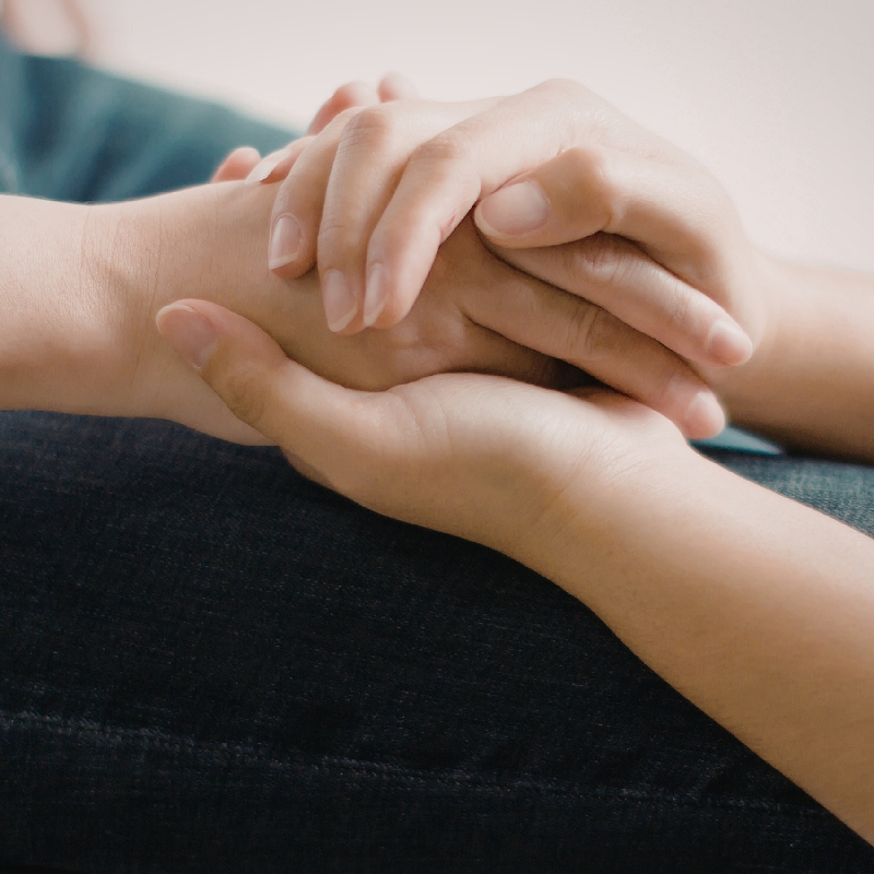 Close-up of supportive hands representing NDIS services Melbourne and compassionate participant care.