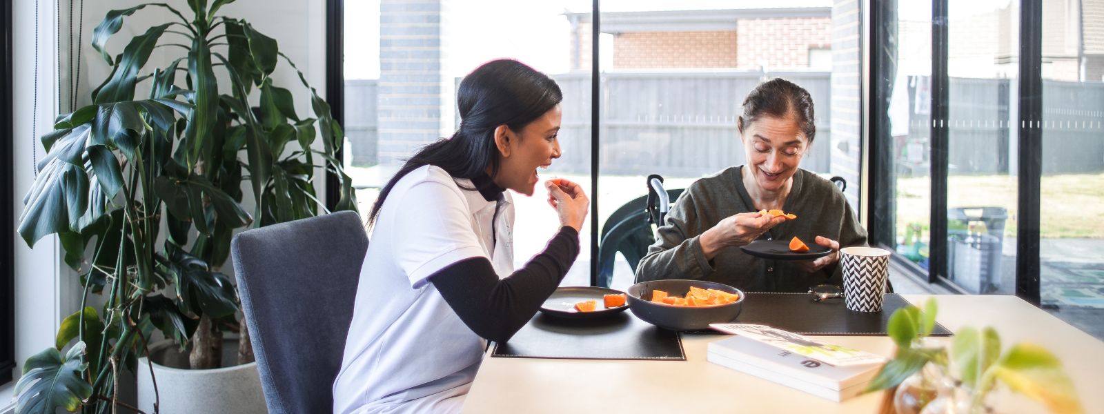 Support worker and NDIS participant reviewing a care routine together at home in Banyule