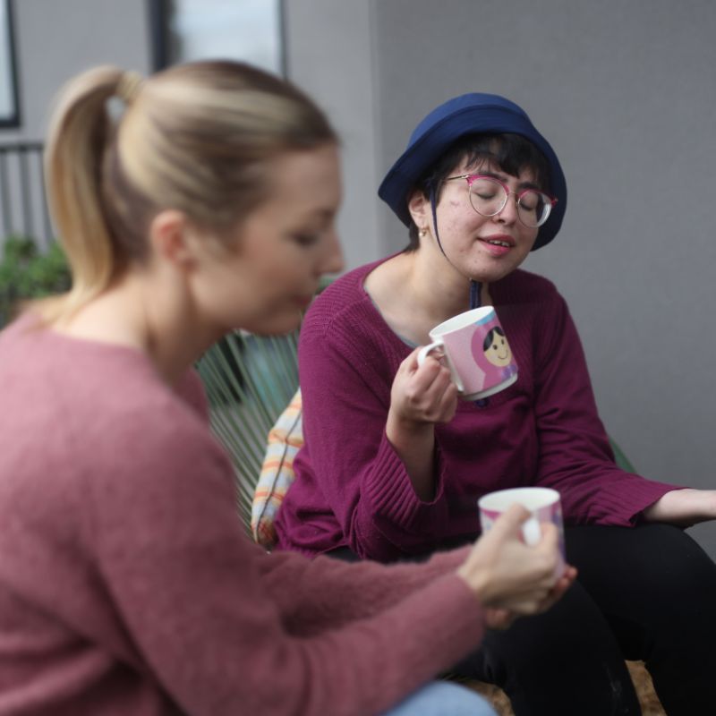 A support worker talking with an NDIS participant at home in Glen Eira