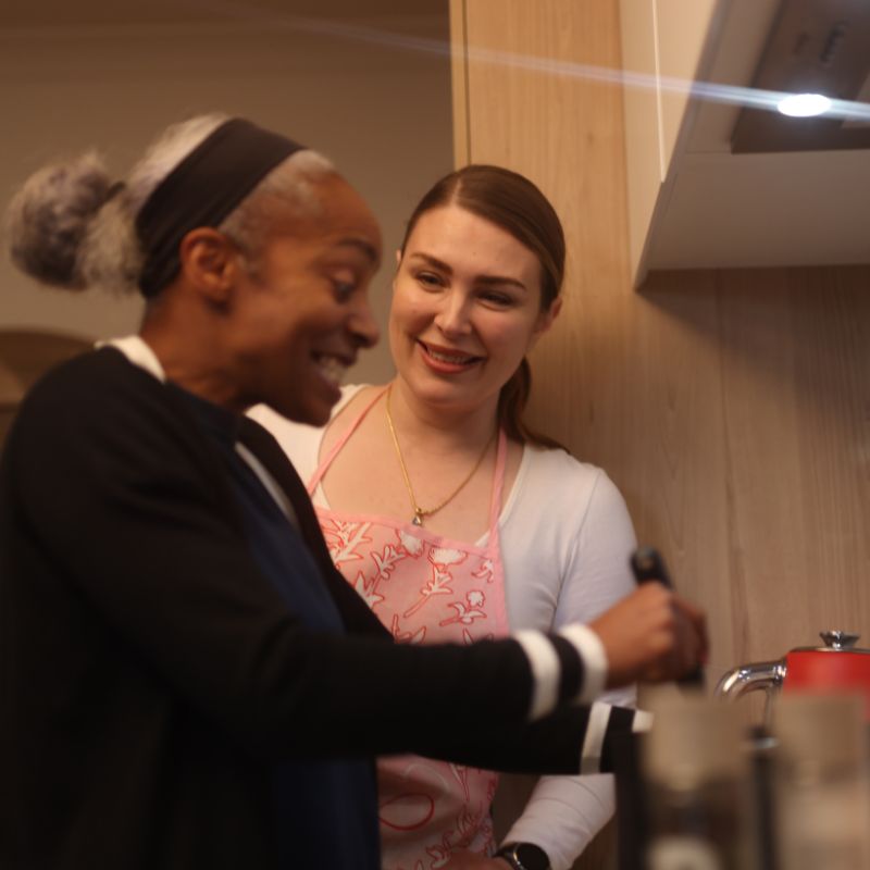 A support worker greeting an NDIS participant at their home in Kingston