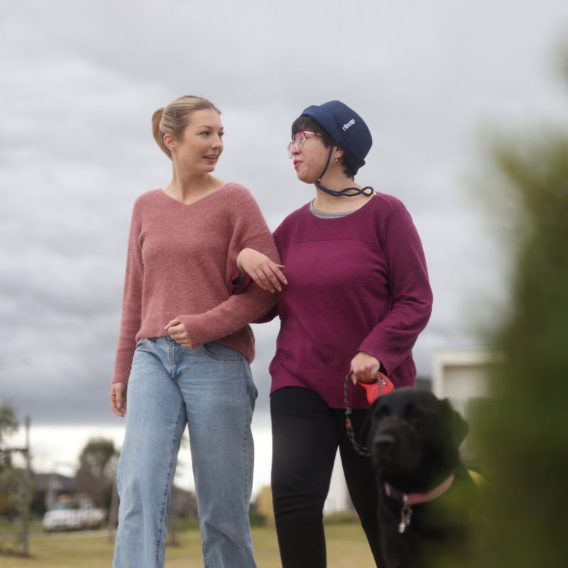 A support worker at the entrance of a converted warehouse apartment in the Yarra area
