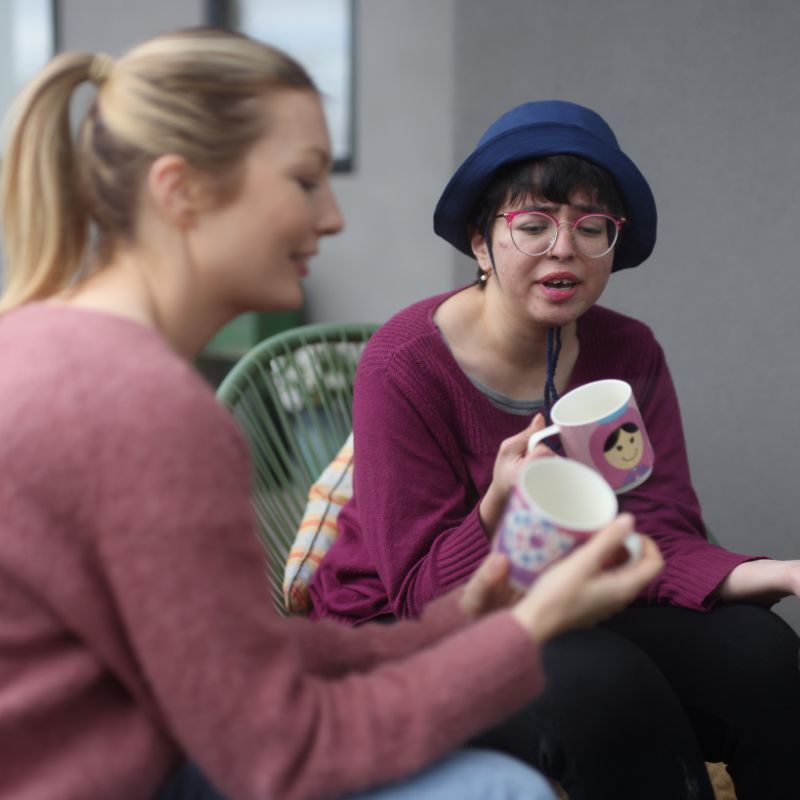 Support worker greeting a participant at the door of a shared home in Port Phillip