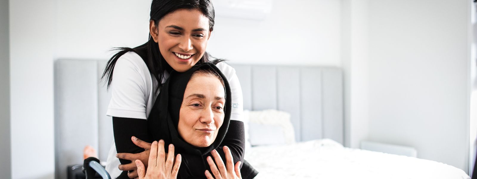 Support worker greeting a participant and their parent at the front door of a home in the Sutherland Shire.