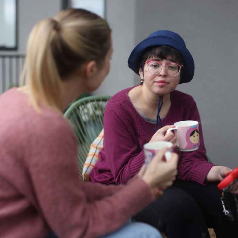 A support worker arriving at an apartment building